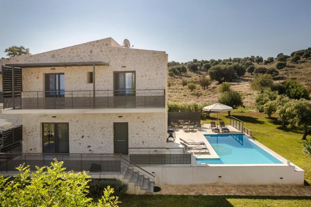 an aerial view of a house with a swimming pool at Petradi Villa Skala I in Skala