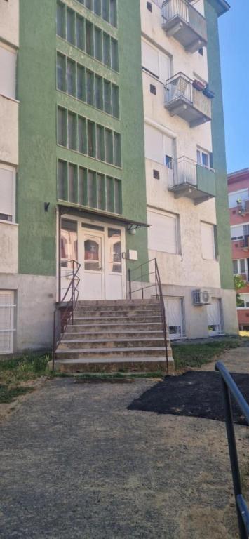 a building with stairs in front of a building at Bella Z Apartman in Kaposvár
