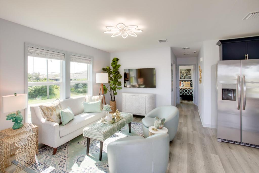 Sunny Fort Myers Home Golf, Shop and Relax! في فورت مايرز: غرفة معيشة بأثاث أبيض ومطبخ