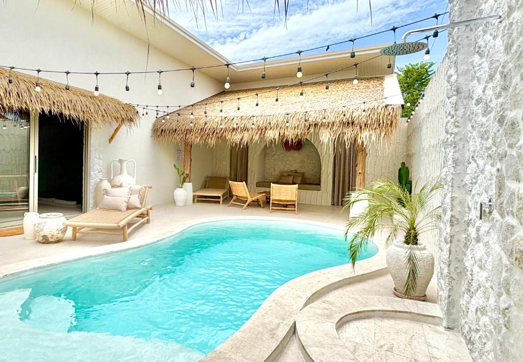 een zwembad in een tuin met een patio bij Bali-Style Villa with Private Pool, 3 Min Walk to Bangrak Beach in Nathon Bay