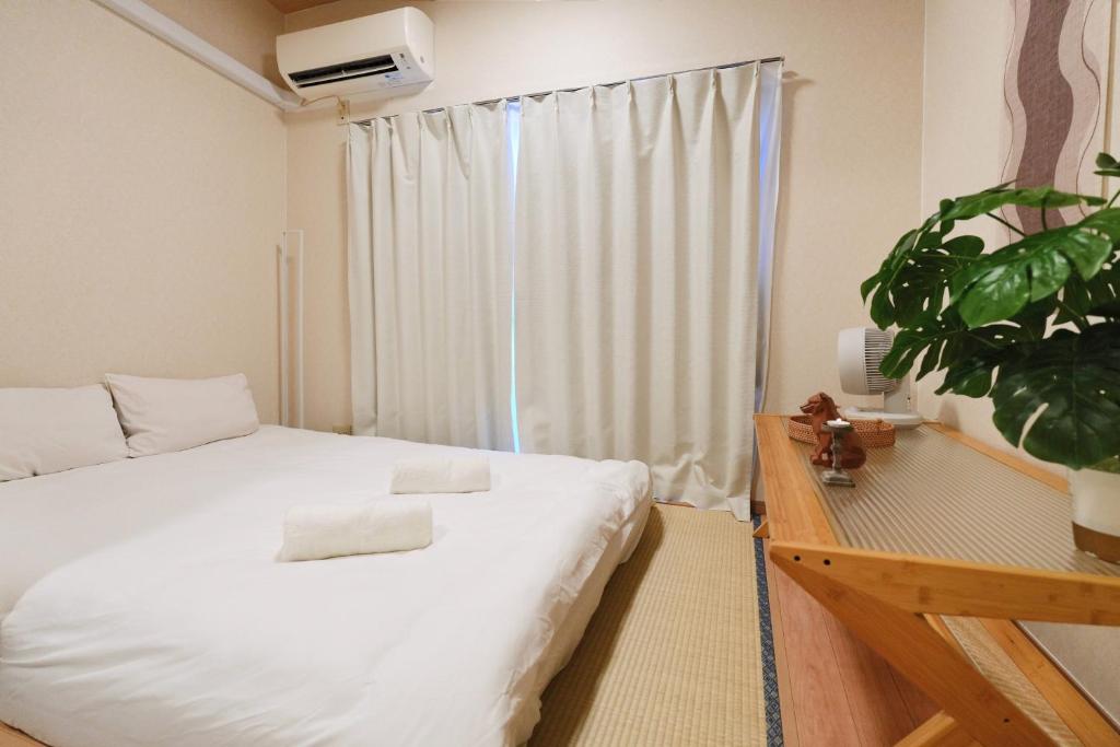 Ένα ή περισσότερα κρεβάτια σε δωμάτιο στο home story in Tokyo Okubo 東京屋語 in 新大久保 新宿