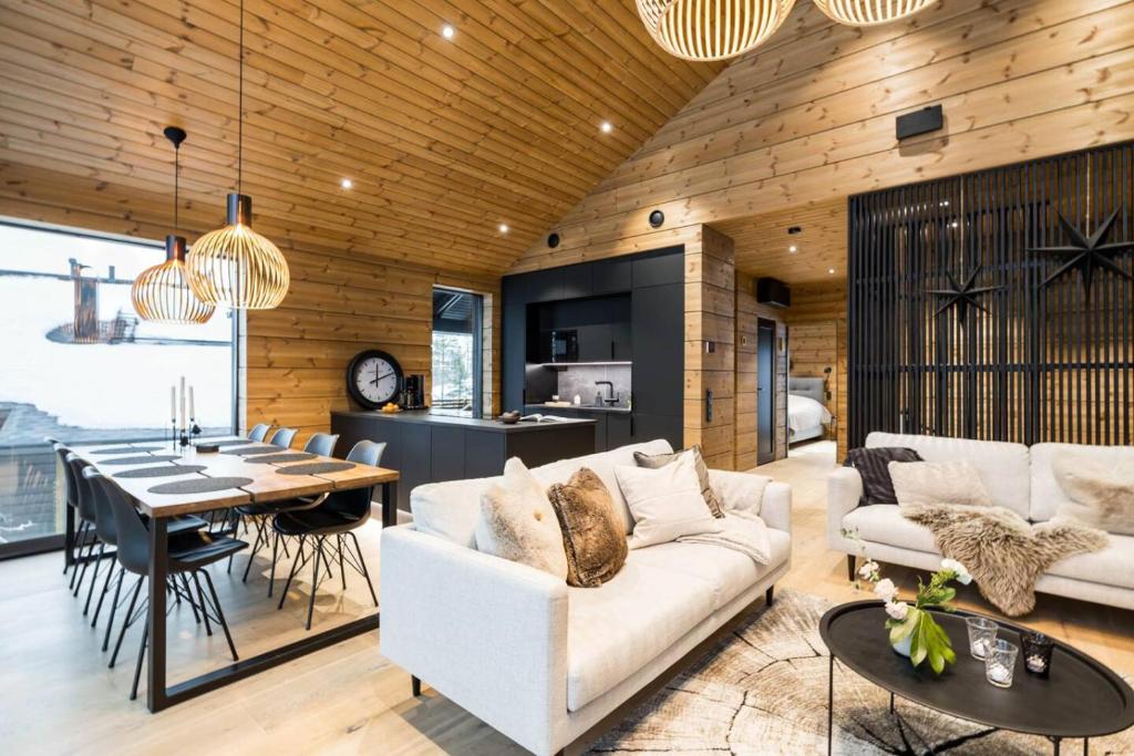 a living room with a white couch and a table at Stay North - Utsunkajo in Kittilä