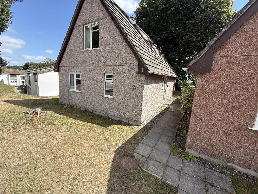 a brick house with a window on the side of it at Hembry Meadows in Callington