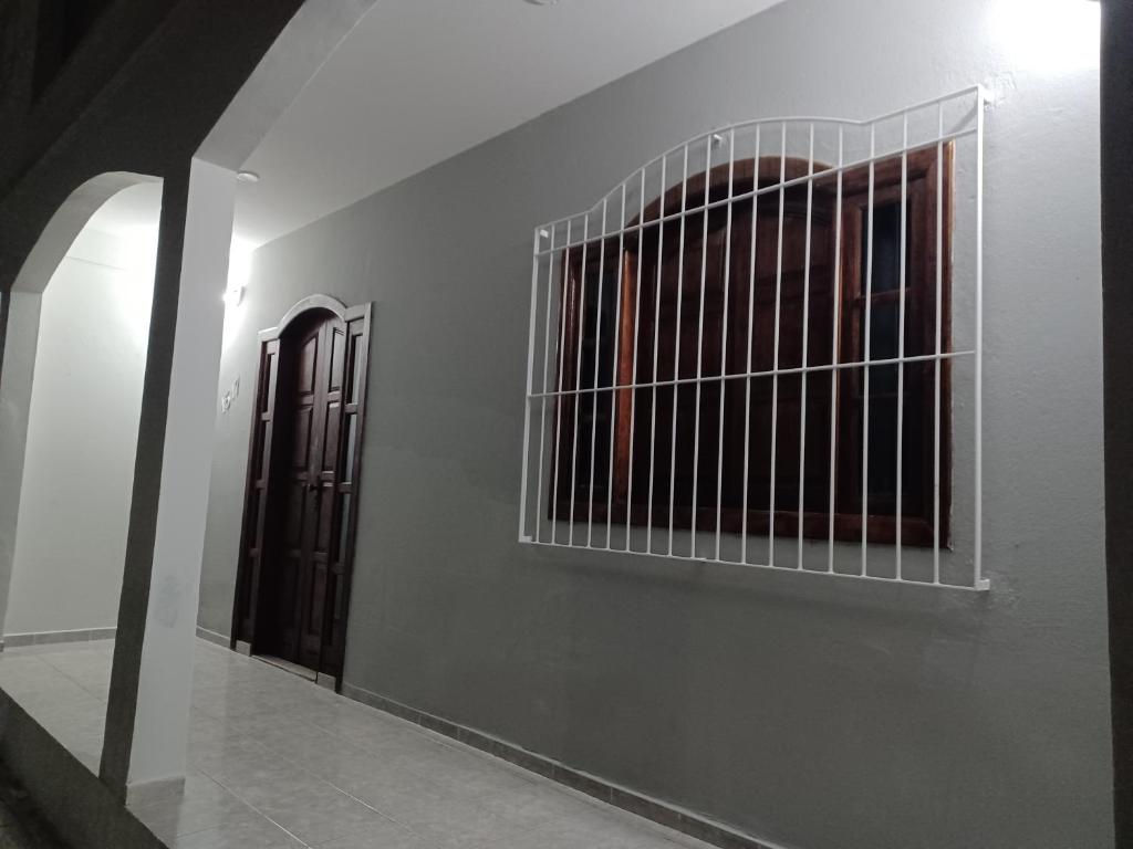 a hallway with two iron gates on a wall at Casa da Sophia in Santa Teresa