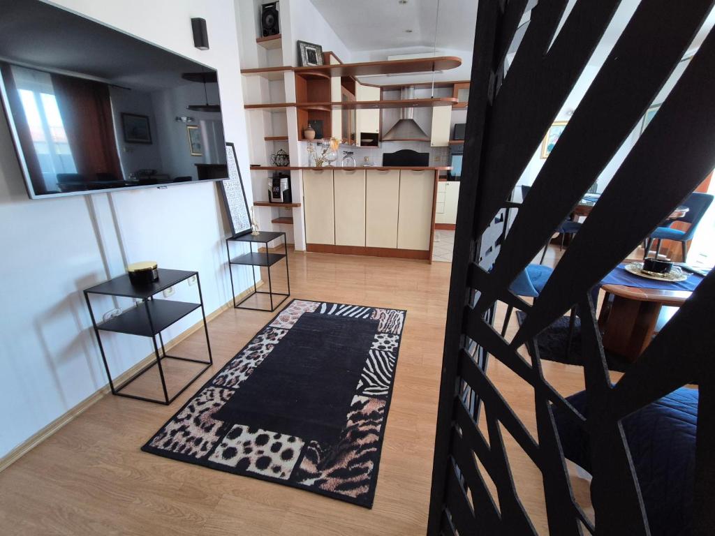a view of a living room and kitchen with a rug at The One in Baška Voda