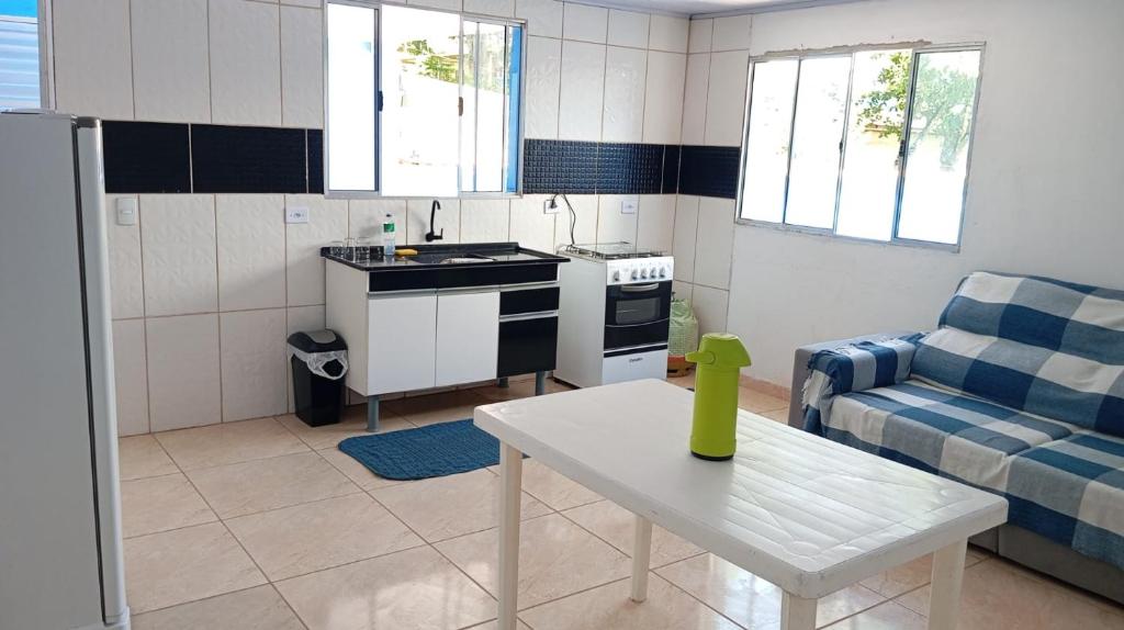 a kitchen and living room with a couch and a table at Espaço tá moiado in Guarulhos