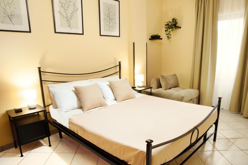 a bedroom with a large bed and a chair at Lovely Fiuggi Apartment - near the Thermal Baths in Fiuggi