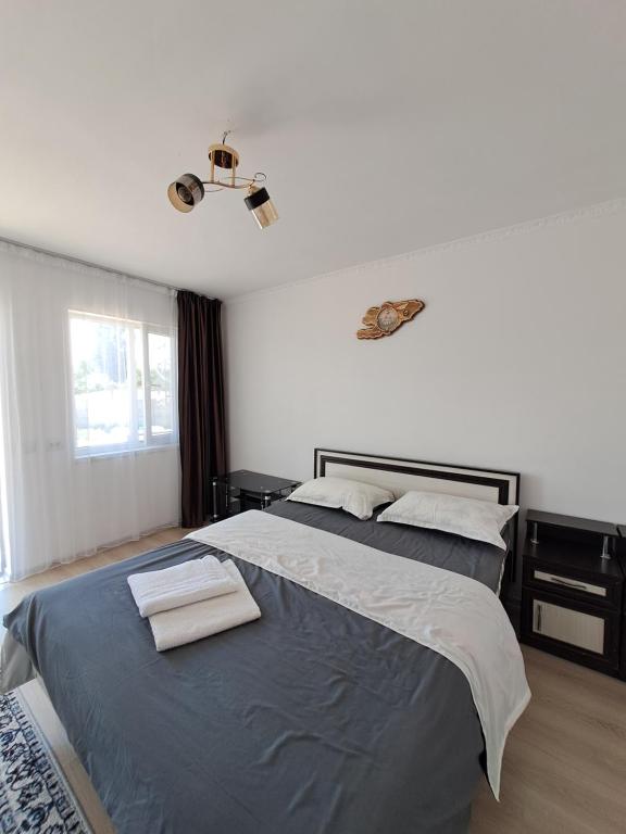 a bedroom with a large bed with two towels on it at "AILUN" Issyk Kul in Tong