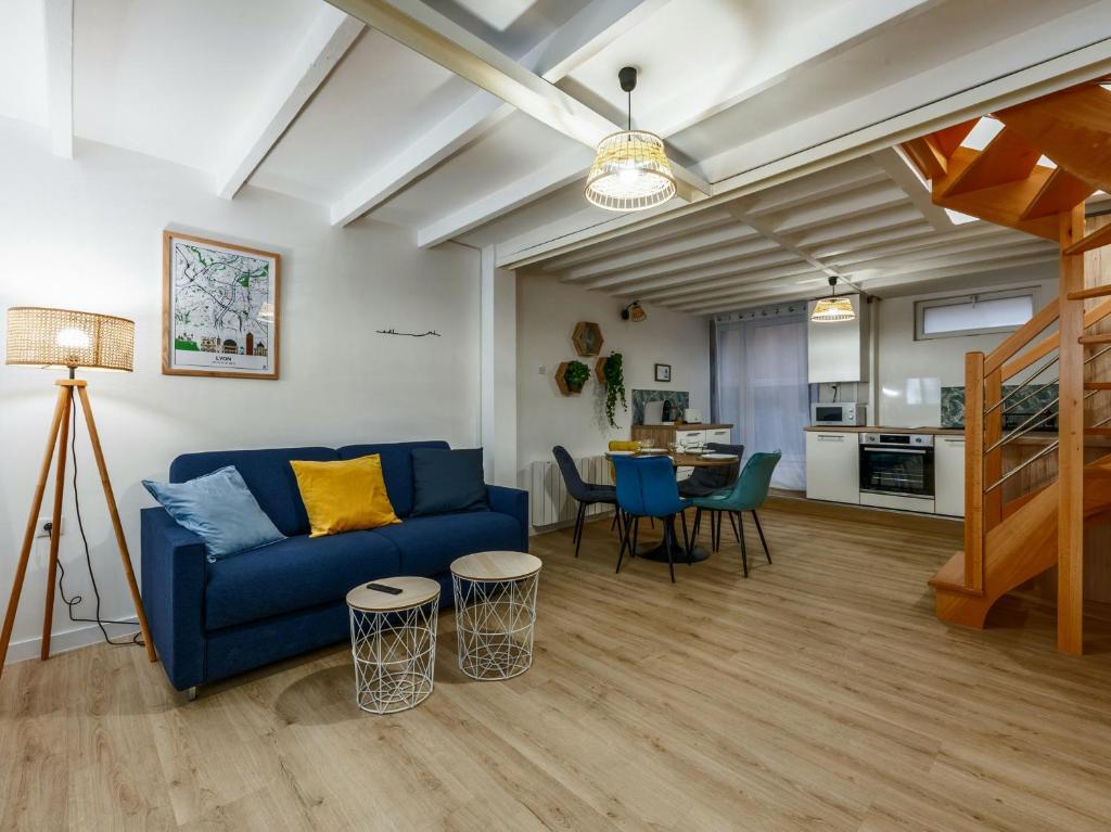 a living room with a blue couch and a table at Cocon Tête d'or in Lyon
