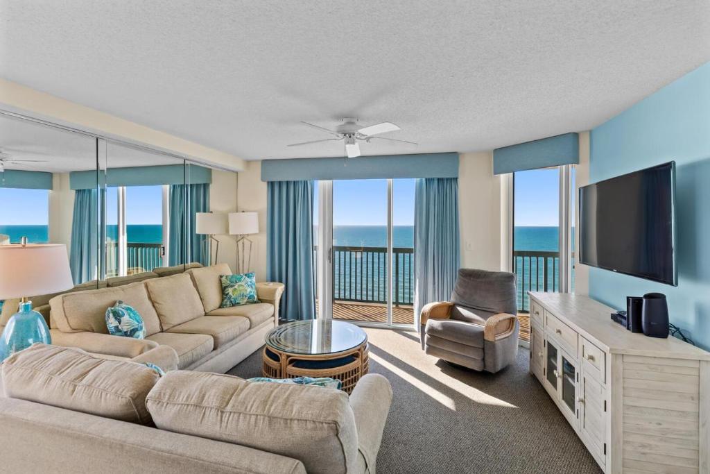 a living room with a couch and a flat screen tv at Ashworth 1709 in North Myrtle Beach