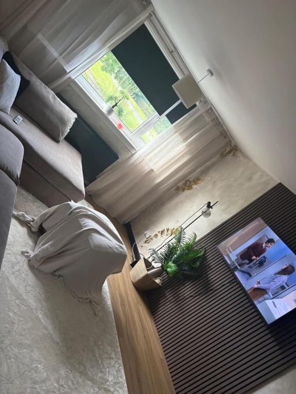 an aerial view of a room with a bed and a window at Modern 1 bedroom flat full flat in East Kilbride