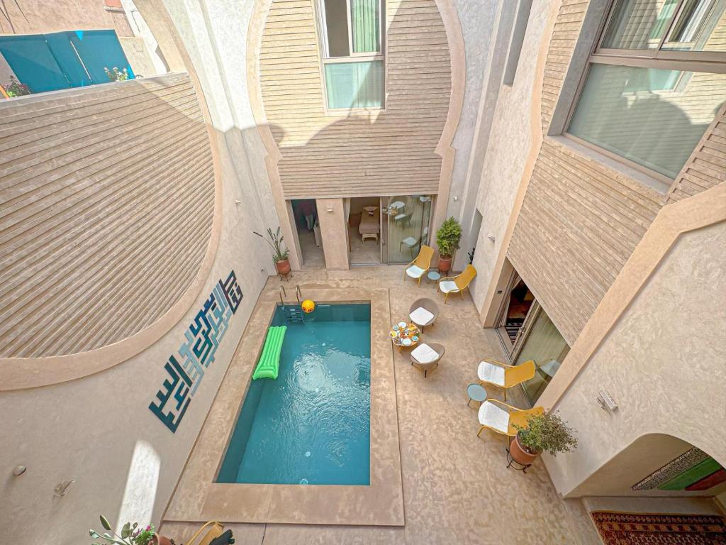 an overhead view of a swimming pool in a building at Riad Timija in Marrakesh