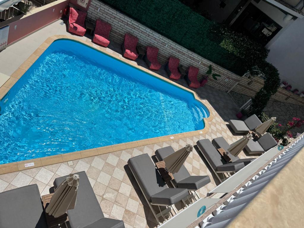 an overhead view of a swimming pool with lounge chairs at Villa Antonis in Parga