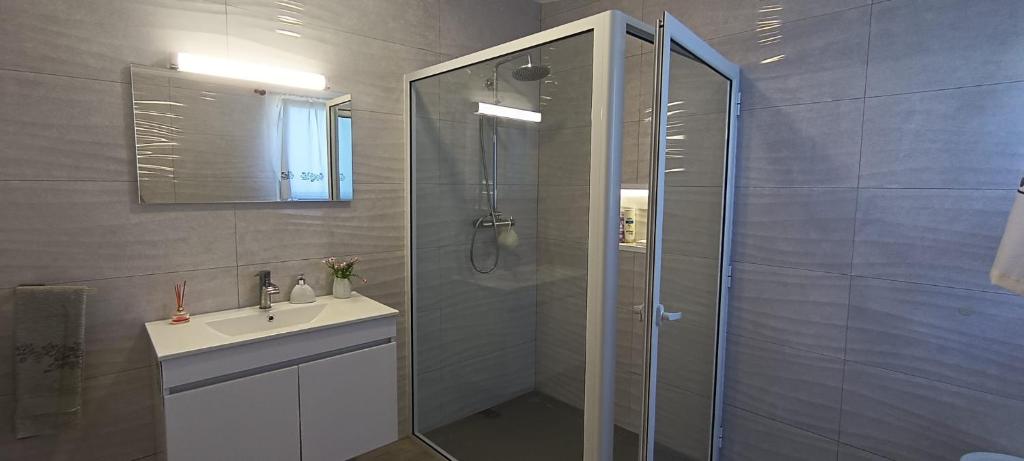 a bathroom with a shower and a sink and a toilet at Casa do Faial da Terra in Fayal da Terra