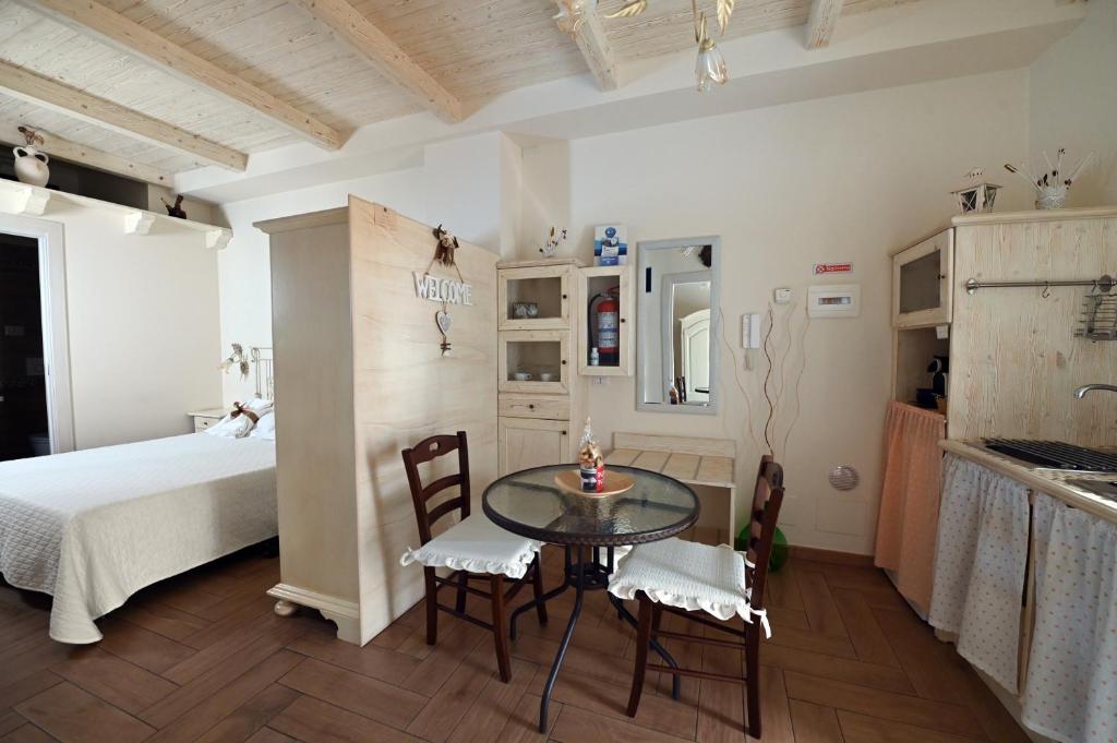 a bedroom with a bed and a table and chairs at Nei pressi dei Sassi in Matera