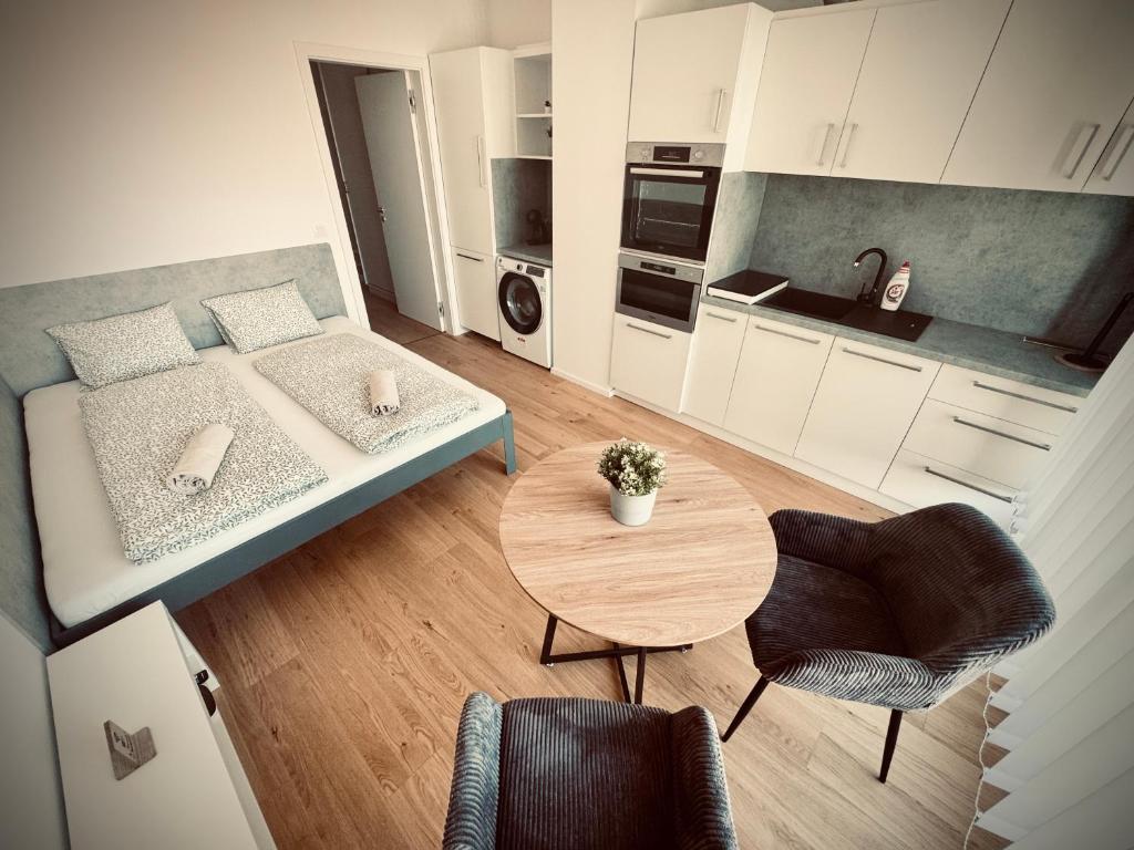 a small living room with a bed and a table at Pekanda apartment in Brno