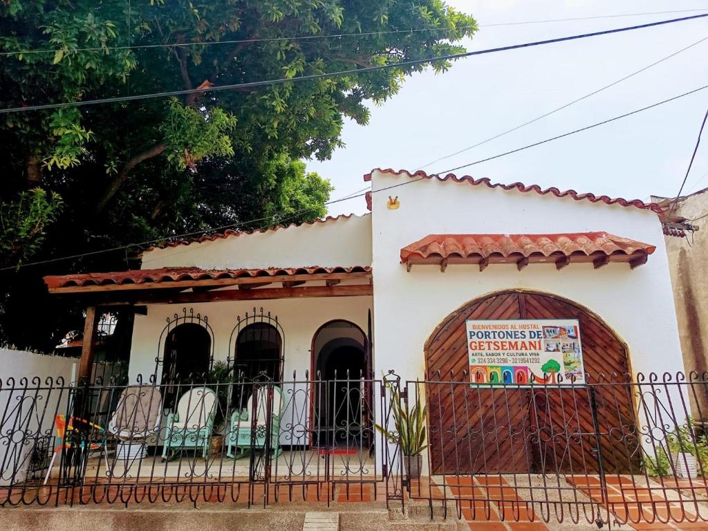 a building with a sign in front of it at hostal portones de getsemani in Cartagena de Indias