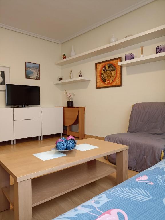 a living room with a coffee table and a couch at Ribadesella Centro, El trasiegu in Ribadesella