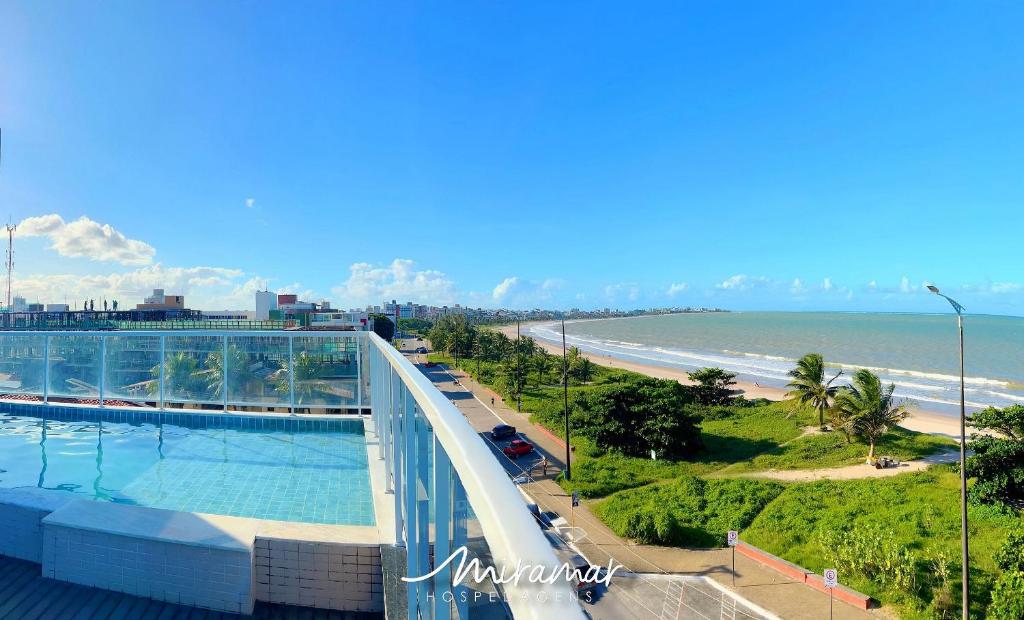 a view of the beach from the balcony of a building at Paradise Beira Mar-Miramar Hospedagens in Nossa Senhora do Livramento