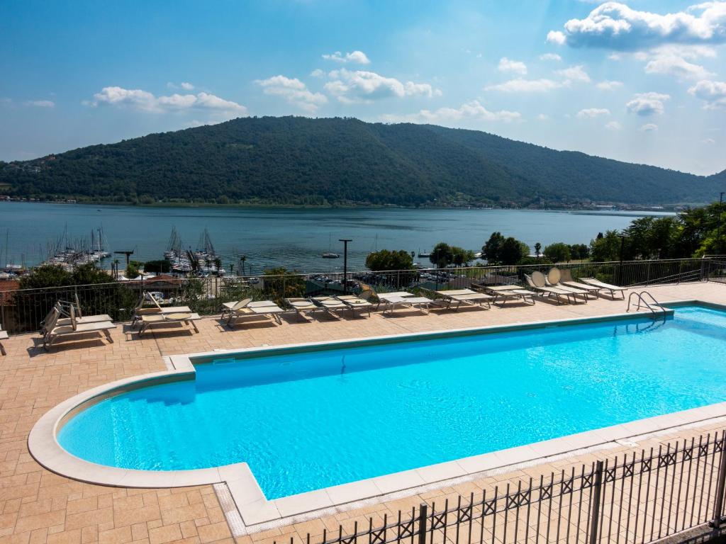 a swimming pool with a view of a lake at La Bella Riva in Sarnico