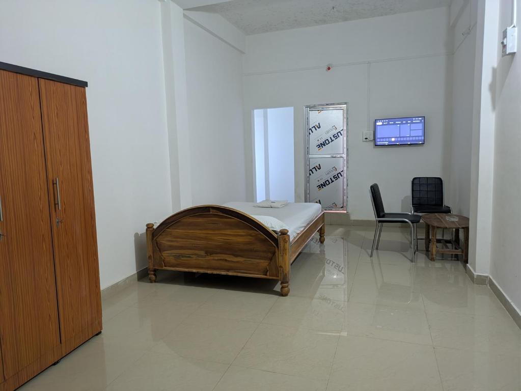 a hospital room with a bed and a desk at Rani guest house in Guwahati