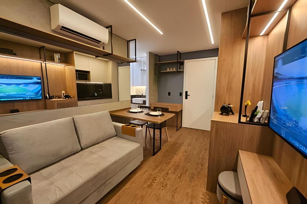 a living room with a couch and a flat screen tv at Today Perdizes - Novo e sofisticado, em frente ao Allianz Parque in Sao Paulo