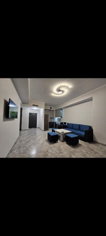 a large living room with blue couches and a table at Alvina SJS in Tsaghkadzor