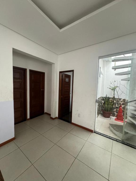 an empty room with two doors and a window at casatemporadabelem in Belém