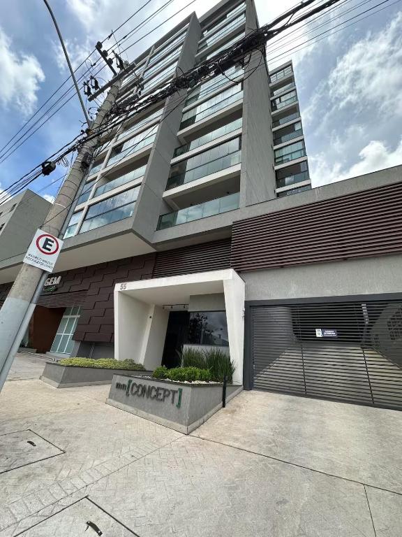 a building with a parking garage in front of it at Edifício Concept in Marília