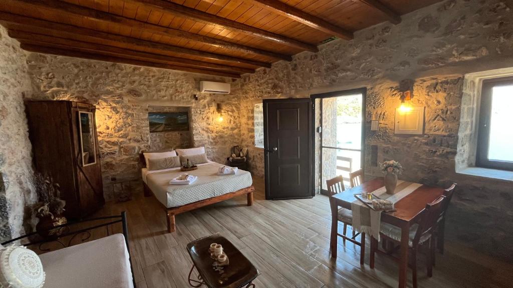 a bedroom with a bed and a table in a room at Villa Lagadaki the sea view in Kótronas