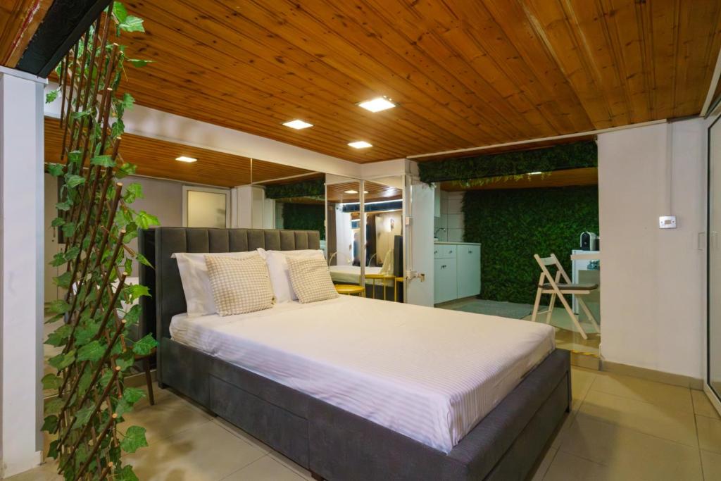 a bedroom with a bed with a wooden ceiling at City Centre Studio Eleftheria Sq in Nicosia
