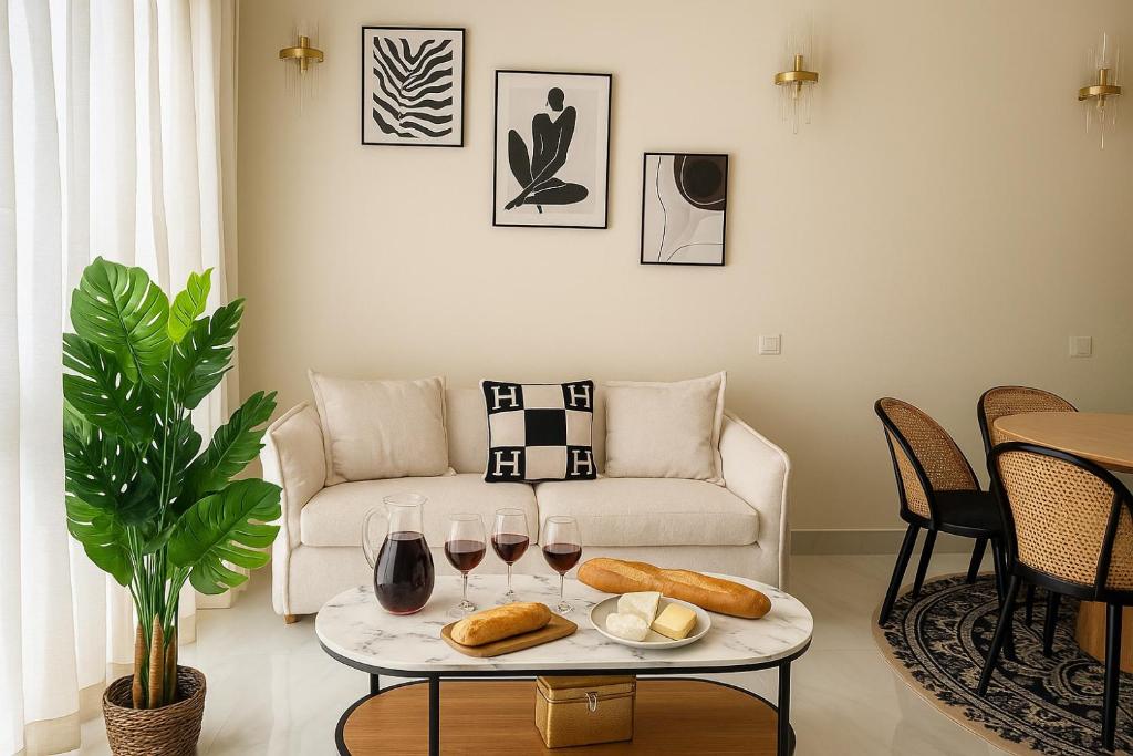 a living room with a couch and a table with wine glasses at 21a Maréchal FOCH Avenue Paris CHAMPS-ELYSÉES in Paris