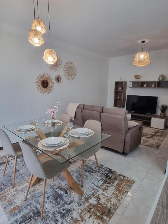 a living room with a glass table and a couch at Apartamento Brisa in Viana do Castelo