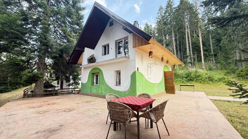 a house with a table and chairs in front of it at Blueberry Mountain House in Žabljak