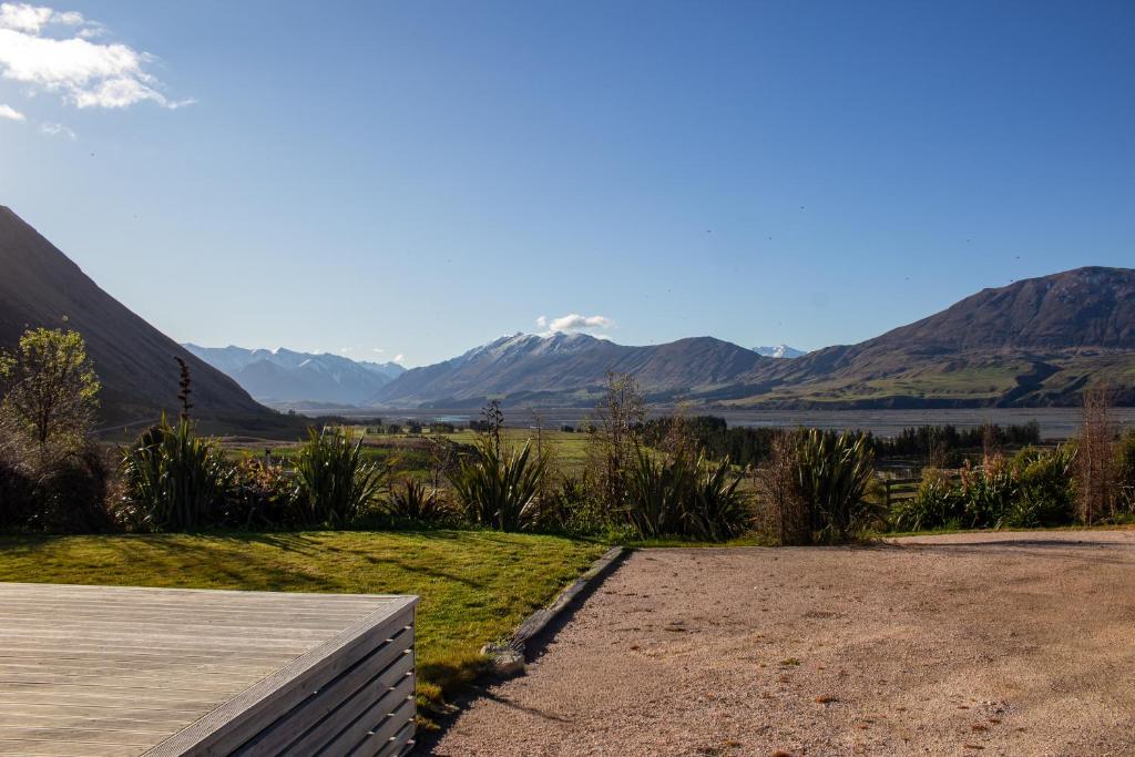 uitzicht op een meer en de bergen vanaf een veranda bij Alpine Views Farm Stay in Lake Coleridge