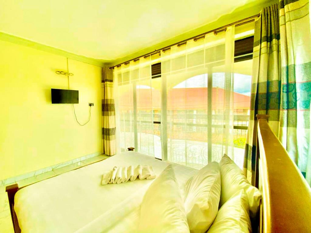 a bed in a room with a window at Superior Courts Hotel in Seeta
