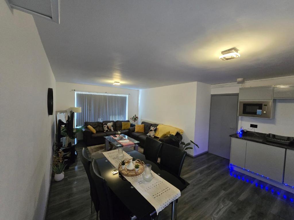 a living room with a couch and a table at Lovely 3 Bed Ground Floor Apartment Near QE Hospital Harborne Birmingham New in Birmingham