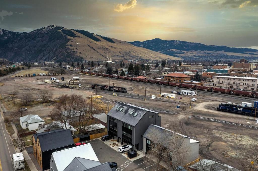 an aerial view of a city with a train yard at The Railway Flats 102 in Missoula