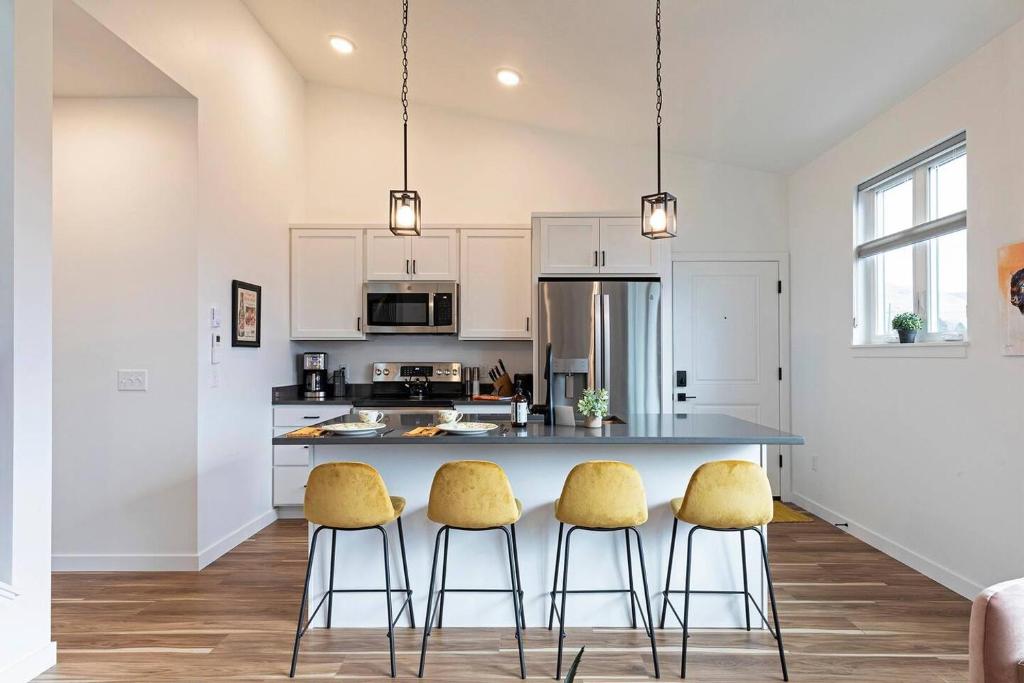 a kitchen with a table and three yellow chairs at The Railway Lofts 201 in Missoula