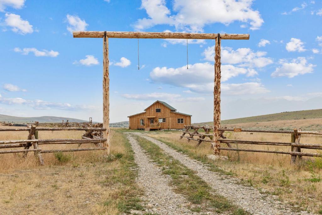 an old farm house in the middle of a field at Red Mountain Ranch- Bitterroot Mountain Views in Victor