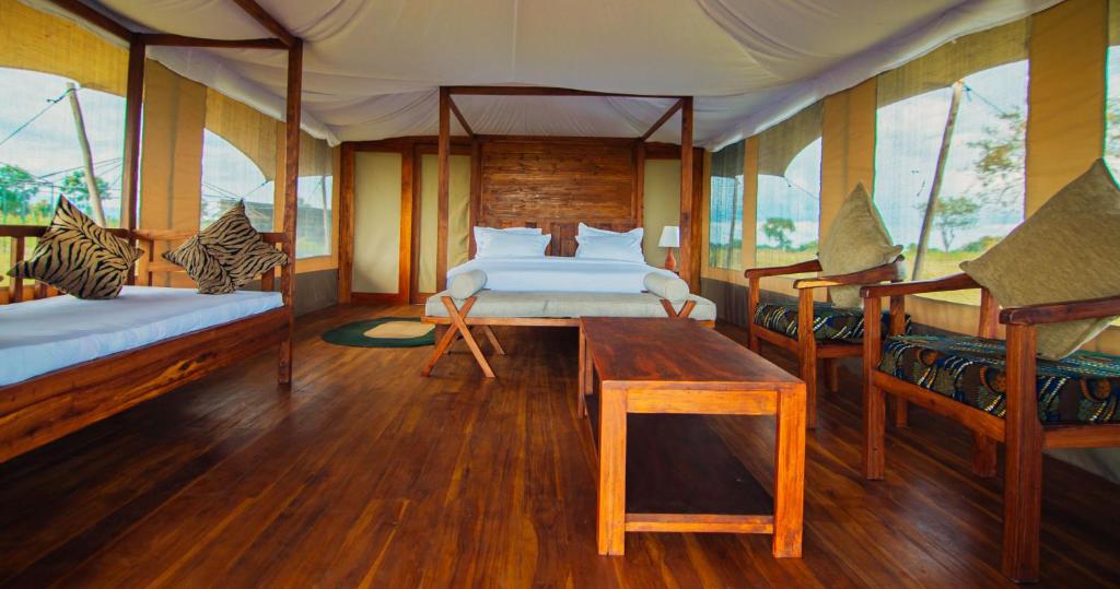 Ένα ή περισσότερα κρεβάτια σε δωμάτιο στο Pumba Luxury Camp - Serengeti