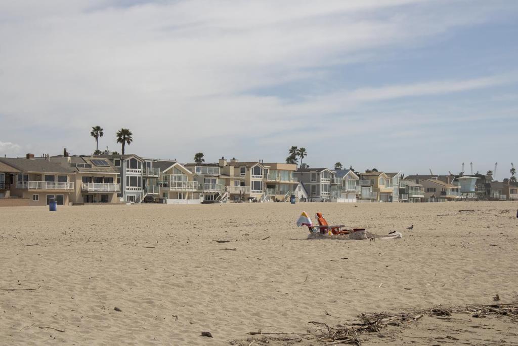 a person laying on a beach with a kite at Dragan's Cove in Oxnard