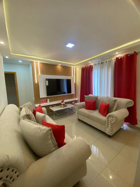 a living room with two couches and a flat screen tv at Nido de Paz Amplio, Moderno y Acogedor in Bonao