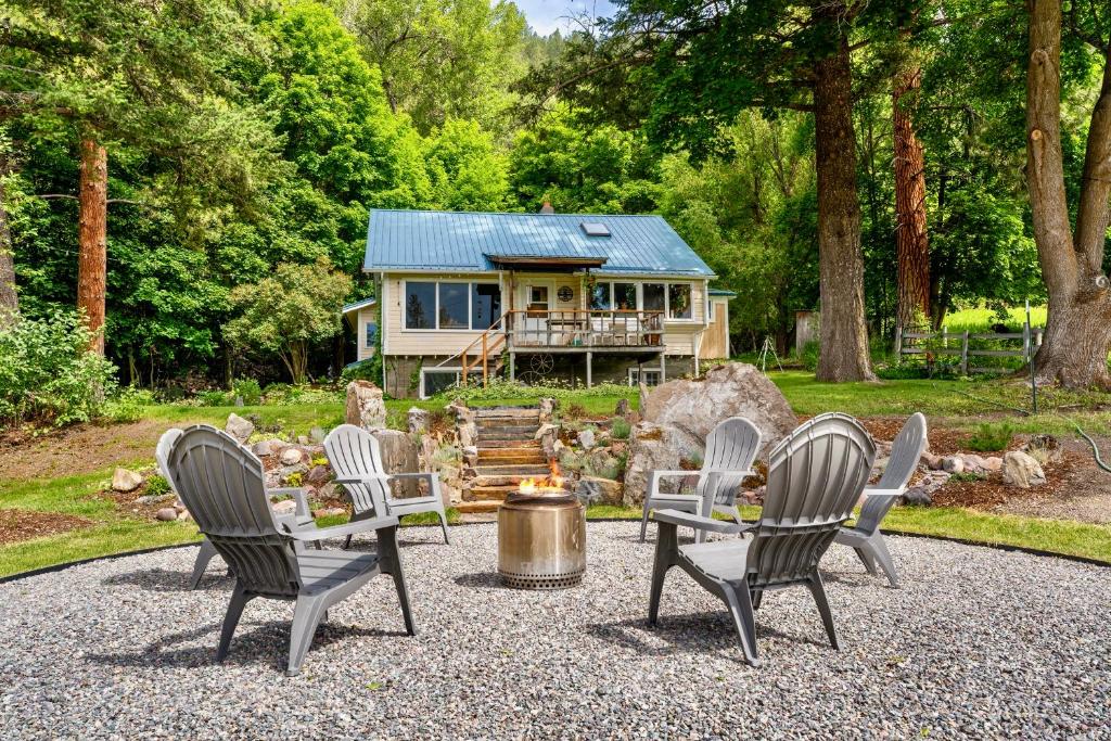 a group of chairs sitting in front of a house at Jocko River Retreat - A Nature Lovers Dream in Arlee