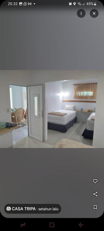 a bedroom with two beds in a room at Casa Tripa Homestay in Meulaboh