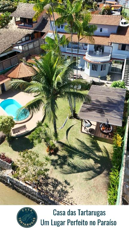 an aerial view of a resort with a palm tree at Casa das Tartarugas in Angra dos Reis