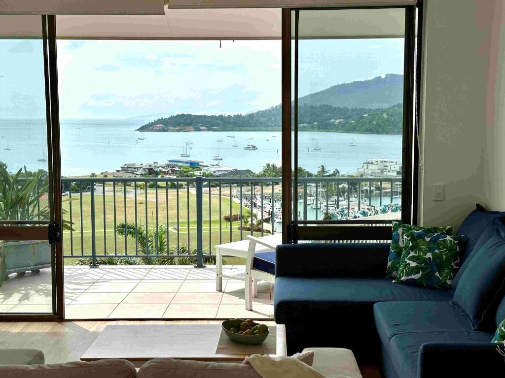 a living room with a view of the ocean at Heavenly Views in Airlie Beach
