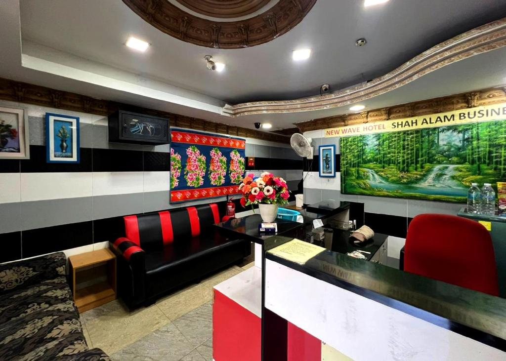 a restaurant with a bar with red and black chairs at ARK Hotel New Wave Shah Alam in Shah Alam