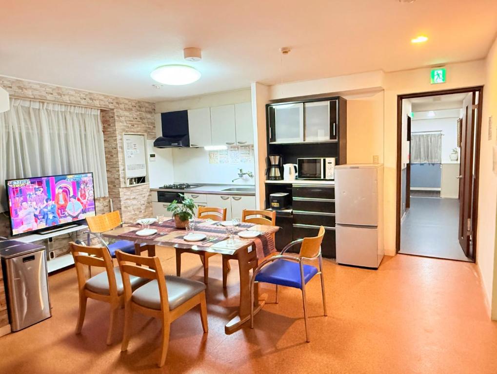 a kitchen and dining room with a table and chairs at M2-3Haneda Lex House 9BDR Max22 people 2WC 2Bath 1min from Sta FreeParking 'Private use in Tokyo