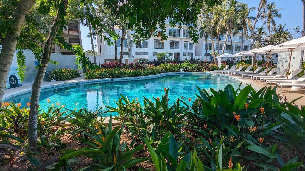 a swimming pool with chairs and a building at Your Perfect Getaway in Vallarta, Pool & Balcony in Nuevo Vallarta